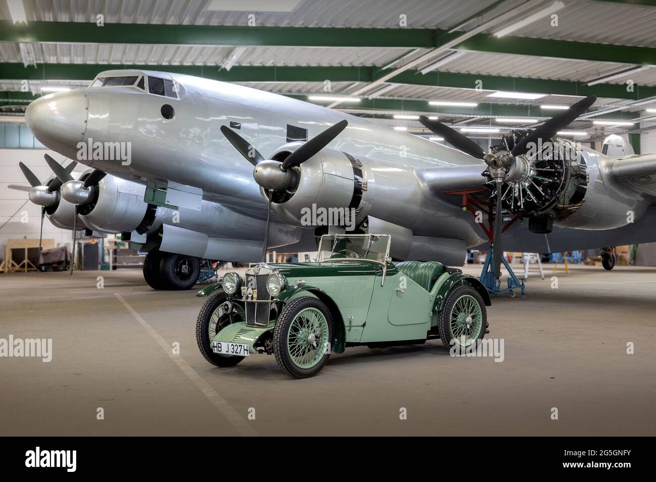 1932 MG J2 Midget in front of the last surviving Focke Wulf FW 200 Condor in a Hangar in Bremen Stock Photo