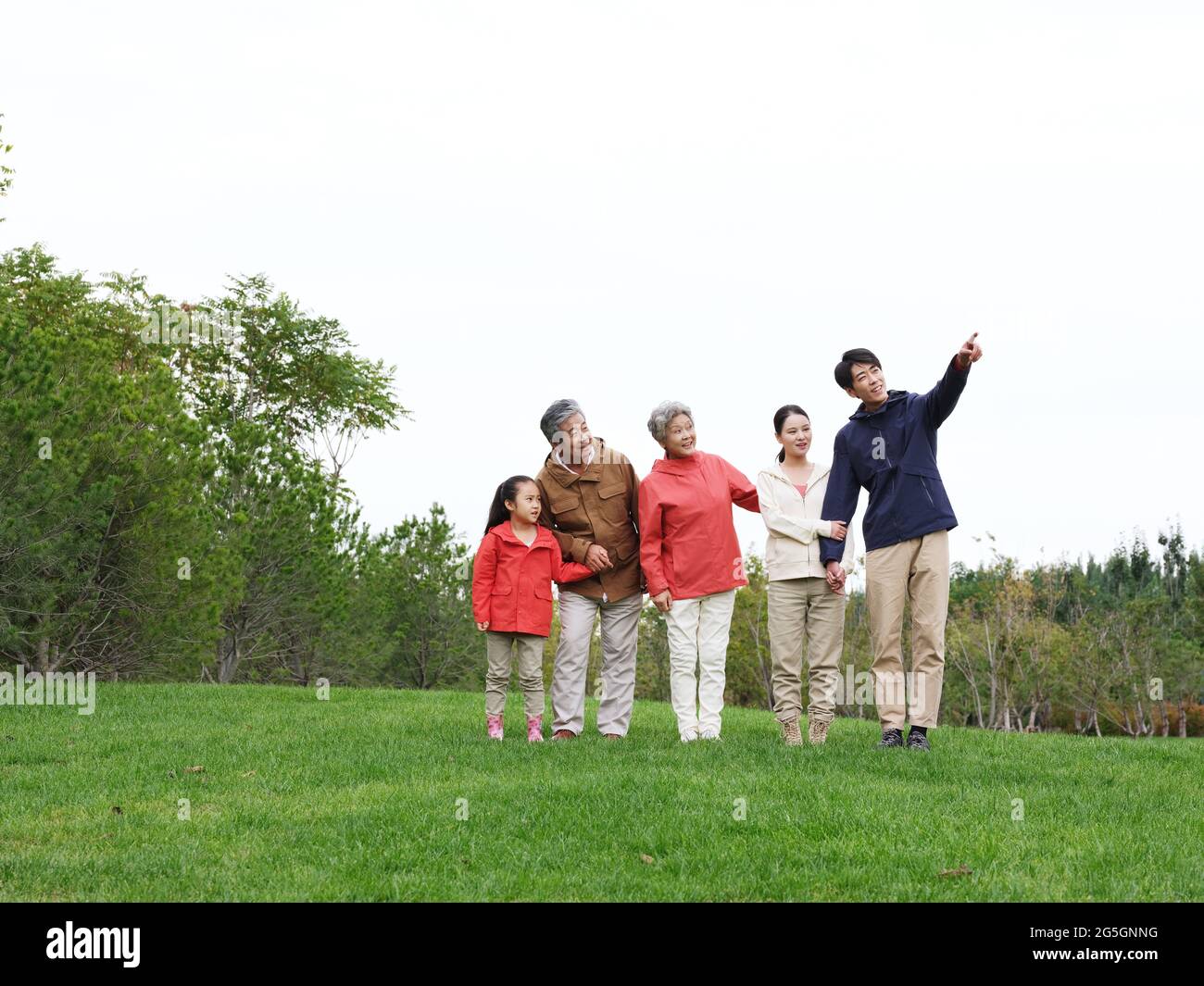 Happy family of five looking at the scenery in the park high quality photo Stock Photo