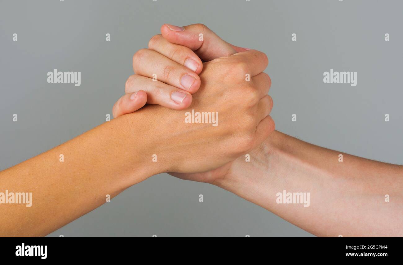 Helping hand. Gesture, sign of help and hope. Two hands taking each other. People handshake. Stock Photo