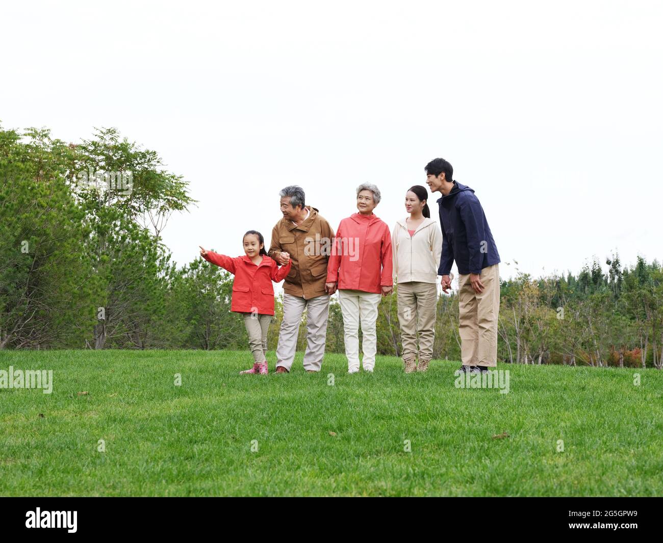 Happy family of five looking at the scenery in the park high quality photo Stock Photo