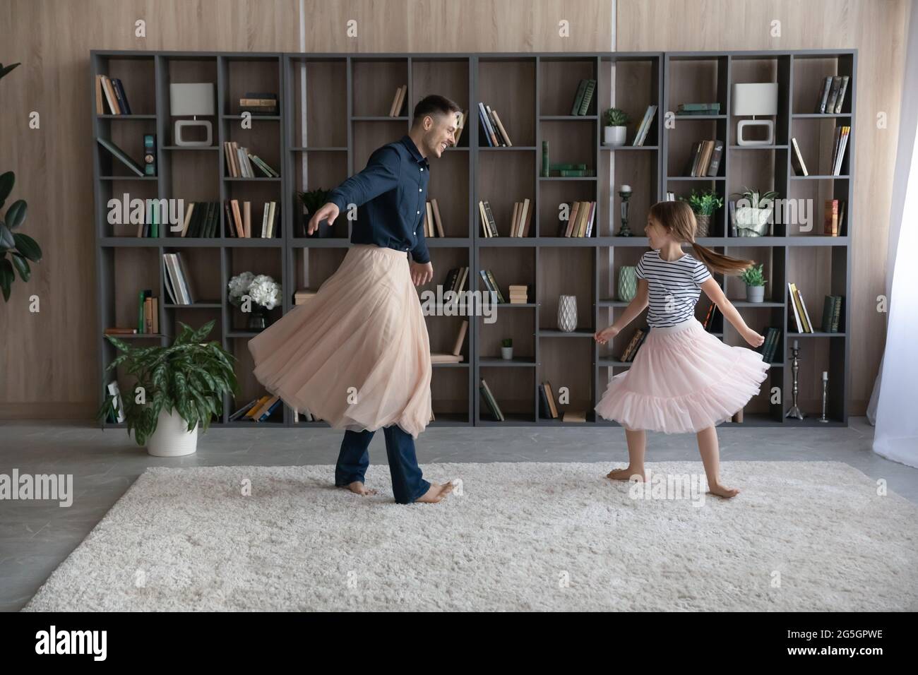 Happy dad in princess skirt play with daughter Stock Photo - Alamy