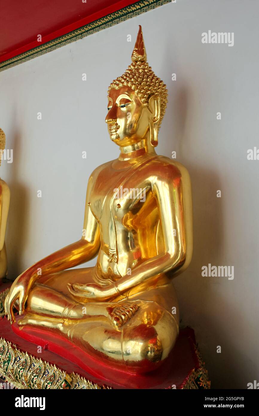 Golden Buddha is in a asian temple. Statues of golden Buddha in ...