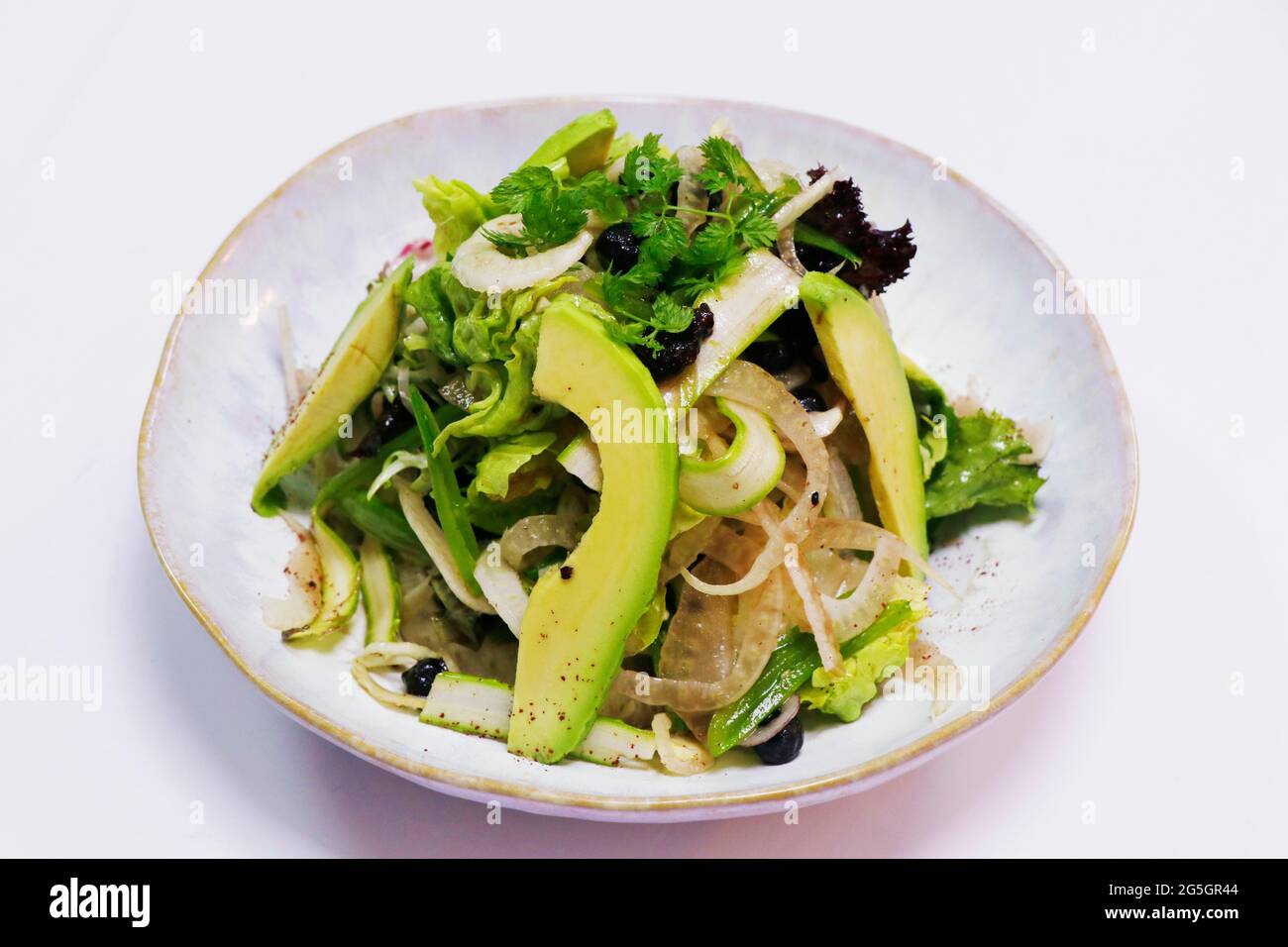 vegetable salad bowl with asparagus, fennel, avocado, raisins and mix lettuce in a bowl Stock Photo