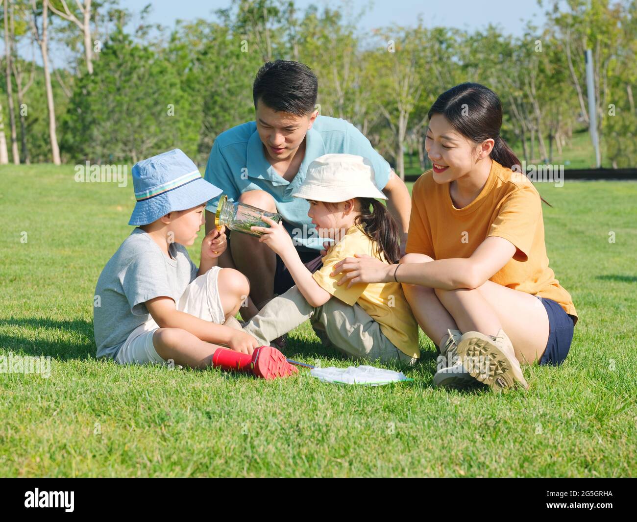 Happy family of four playing in the park high quality photo Stock Photo ...