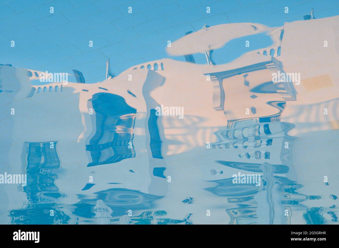 Pool water with hotel building reflections. Distorted, blurred ...