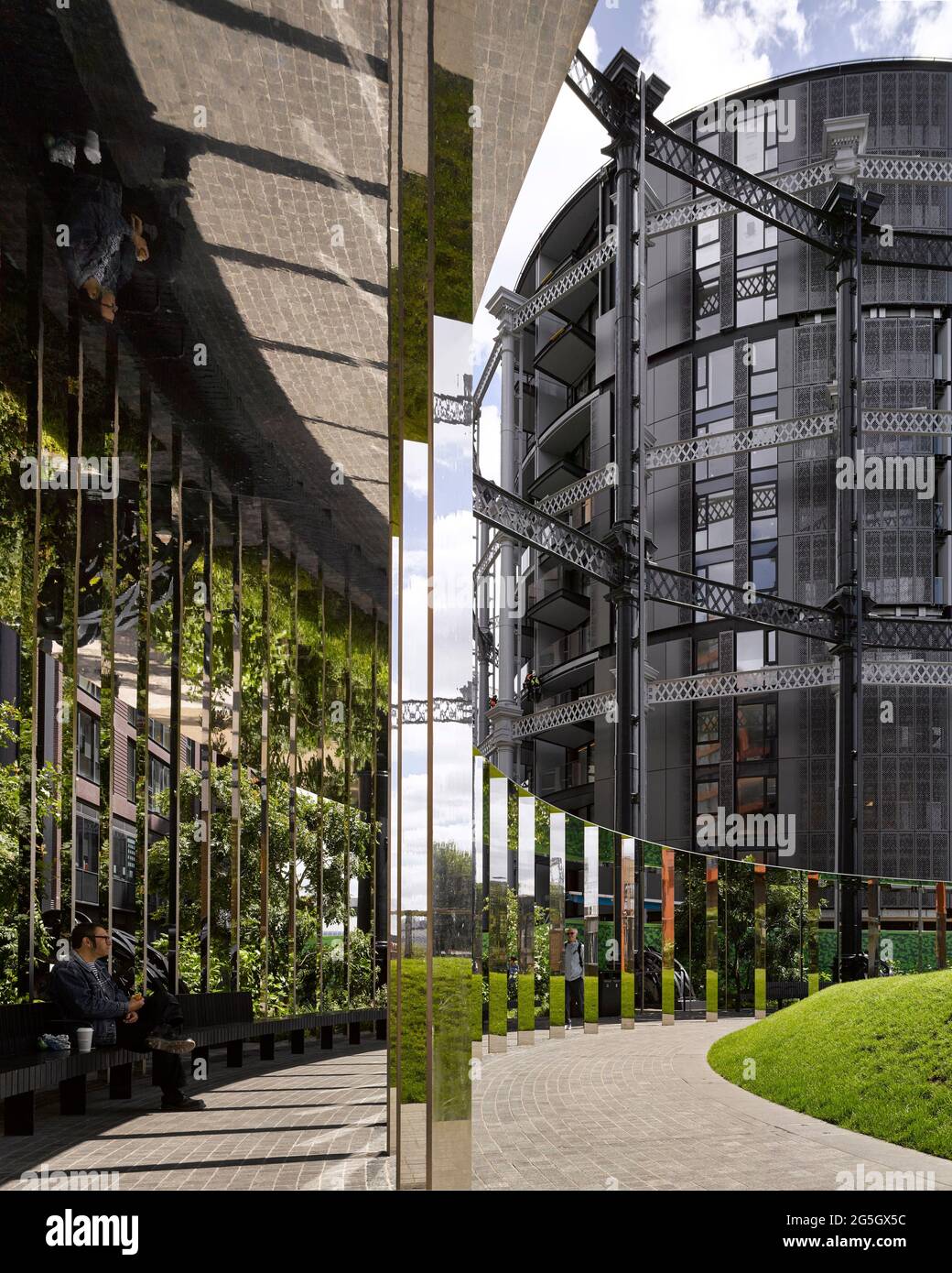 View through mirrored walkway structure. Gasholder Park, London, United