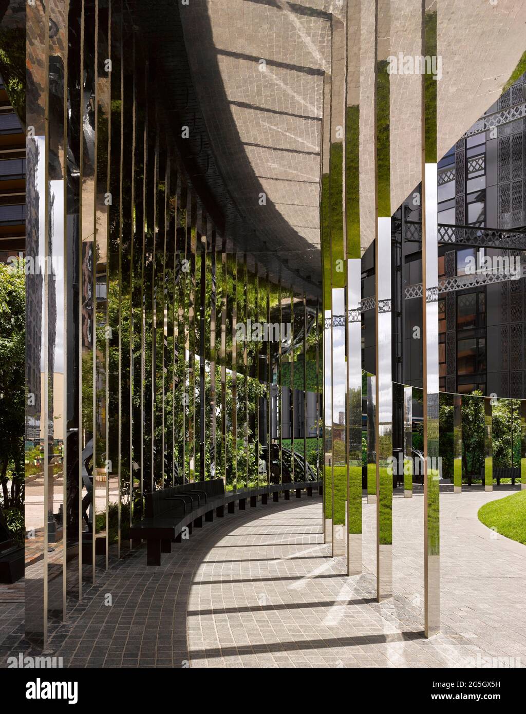 View through mirrored walkway structure. Gasholder Park, London, United
