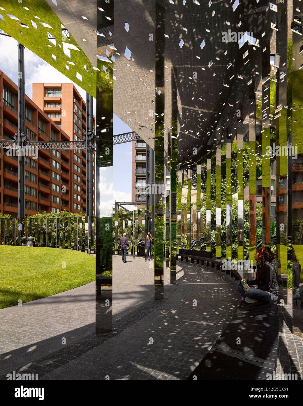 View through mirrored walkway structure. Gasholder Park, London, United