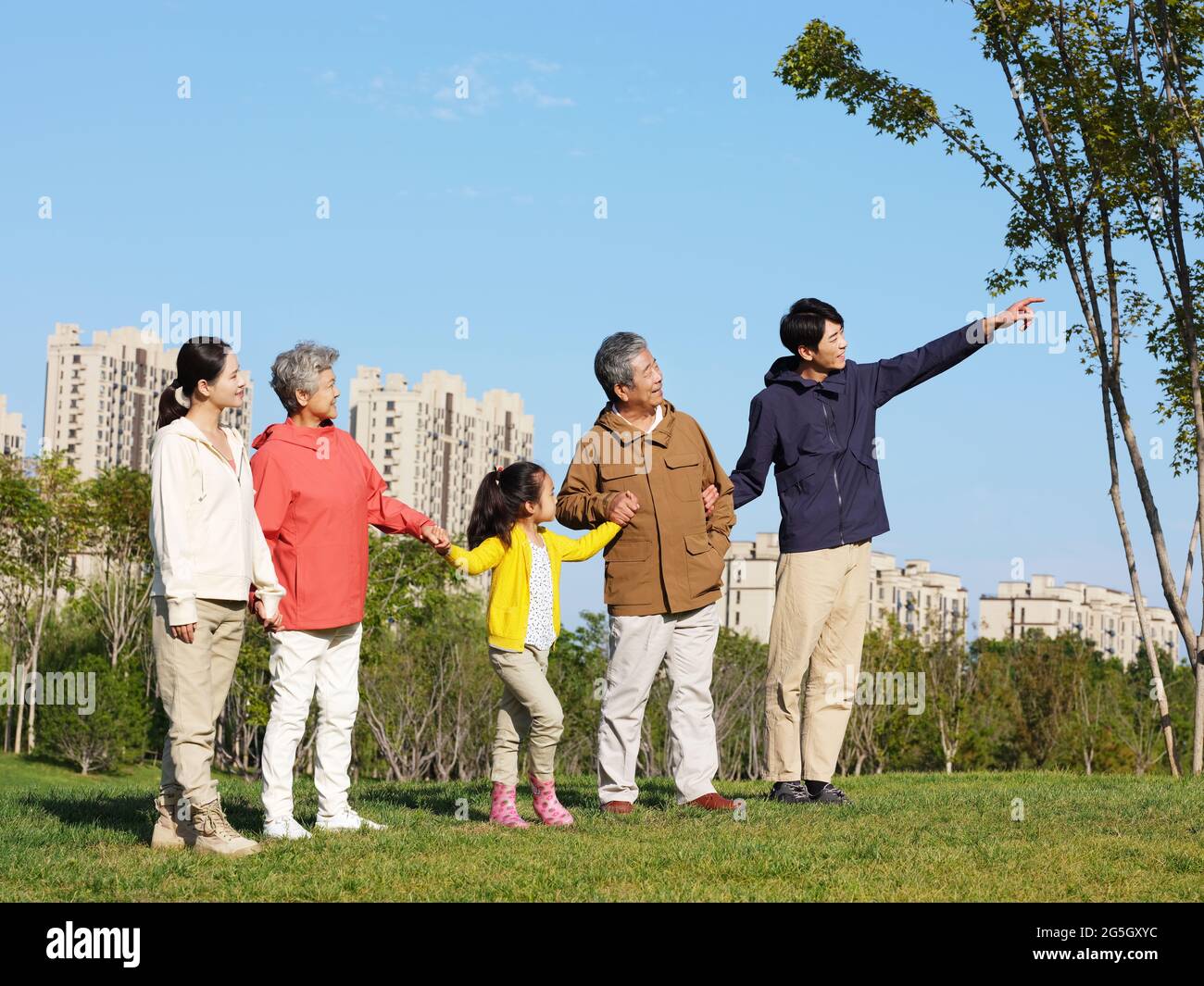 Happy family of five looking at the scenery in the park high quality photo Stock Photo