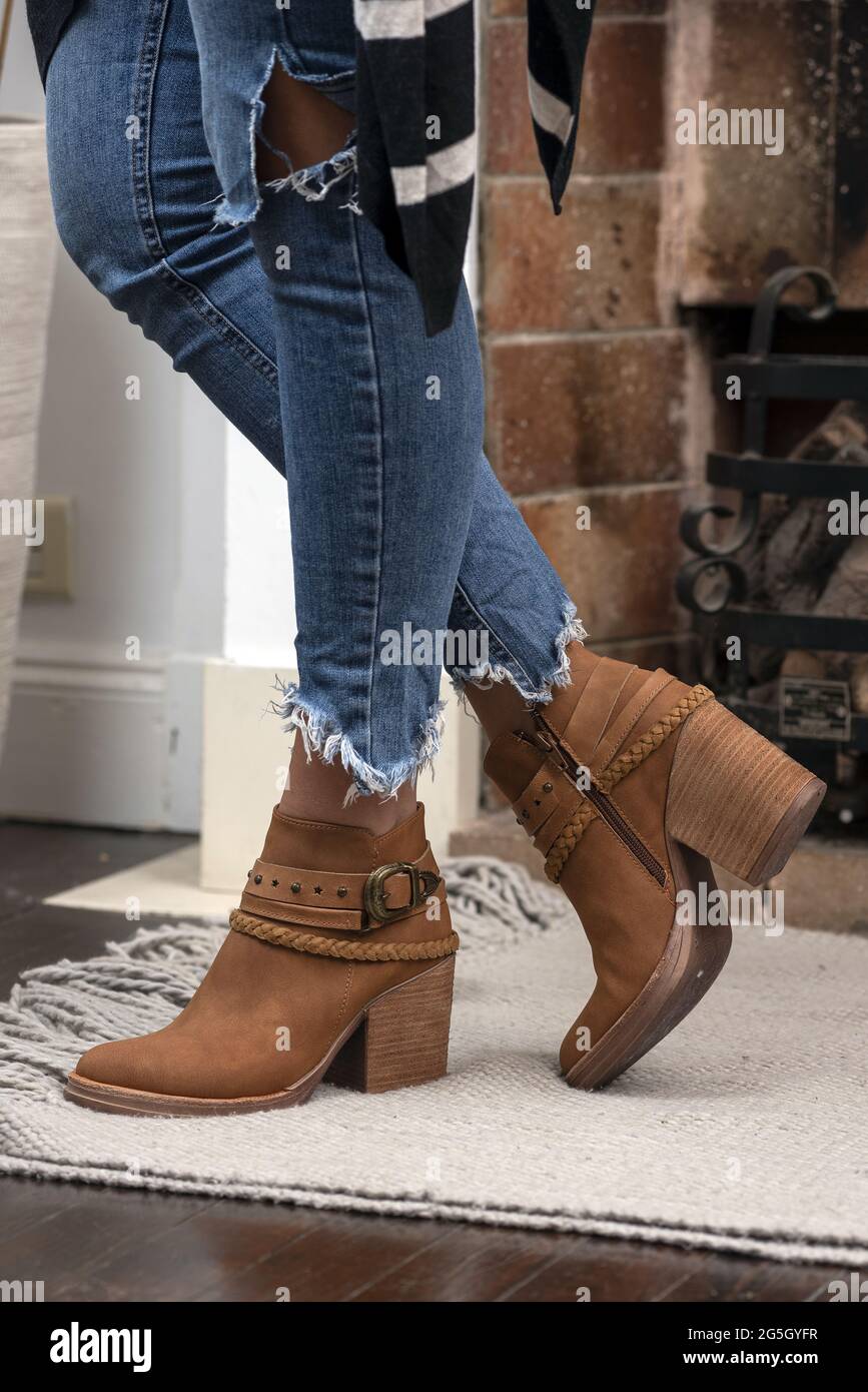 A vertical shot of a woman wearing boots indoors Stock Photo - Alamy