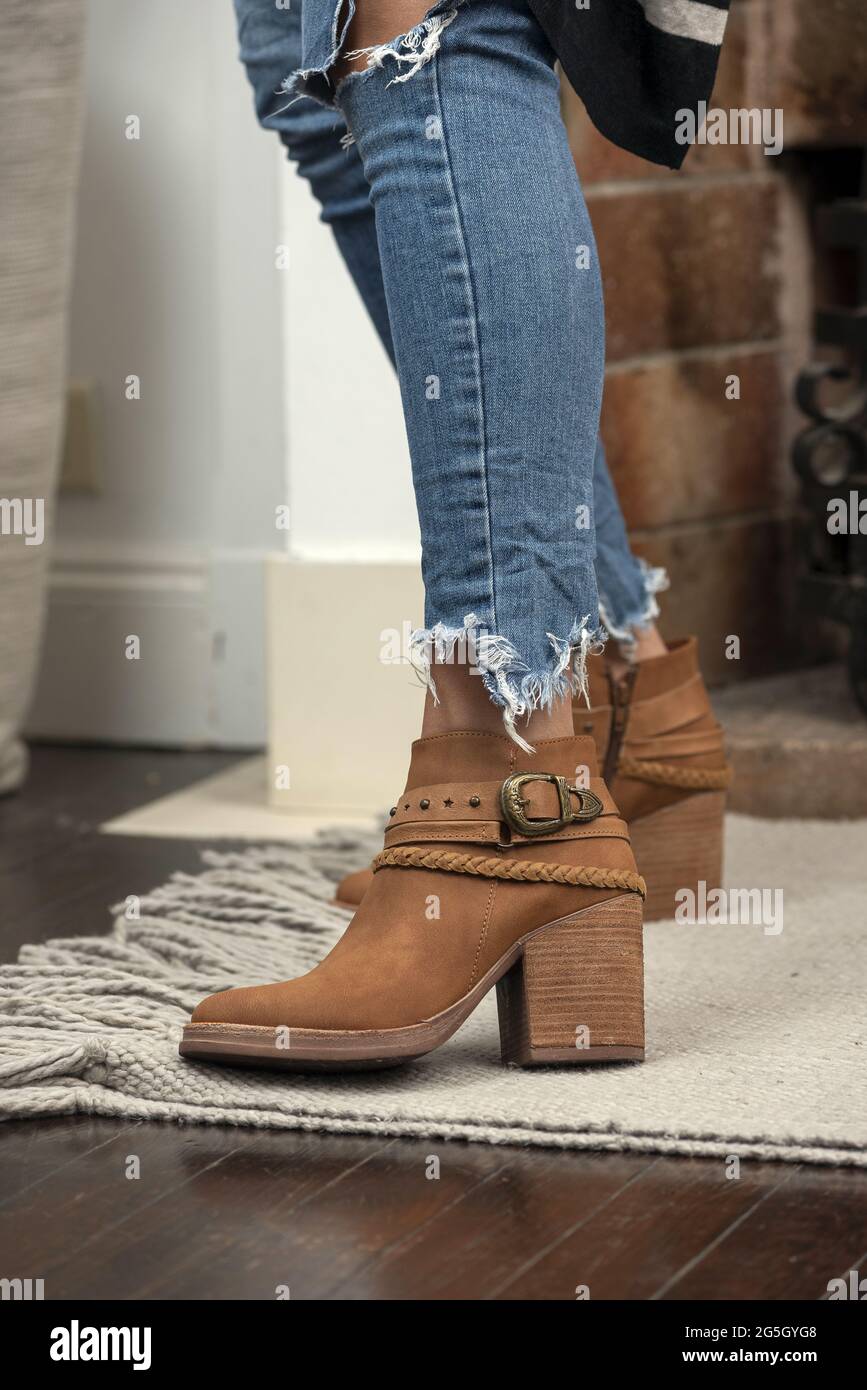 A vertical shot of a woman wearing boots indoors Stock Photo - Alamy