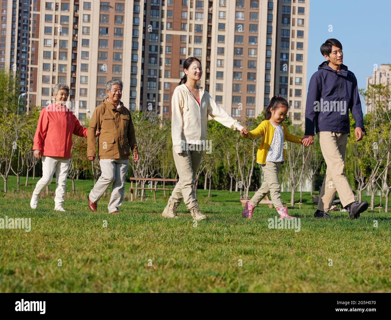 A happy family of five walking in the park high quality photo Stock ...