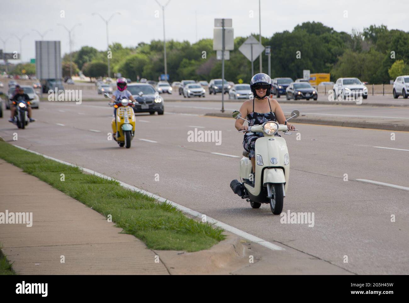 Plano, USA. 27th June, 2021. People ride Vespa during the National Vespa Parade Day in Plano, Texas, the United States, on June 27, 2021. Nearly 50 Vespa enthusiasts participated in a Vespa parade in Plano on Sunday. Credit: Dan Tian/Xinhua/Alamy Live News Stock Photo