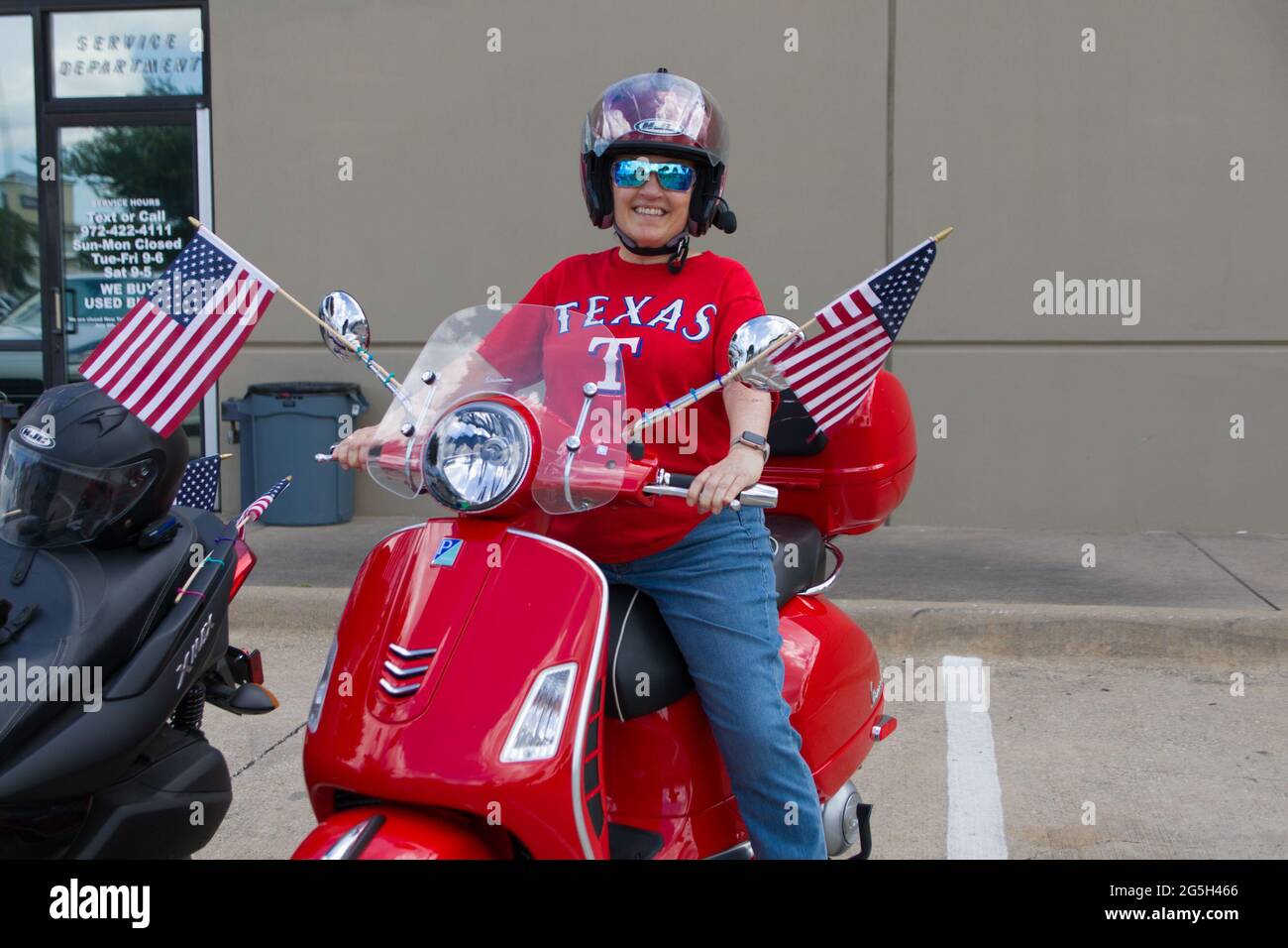 Plano, USA. 27th June, 2021. A woman prepares to ride Vespa during the