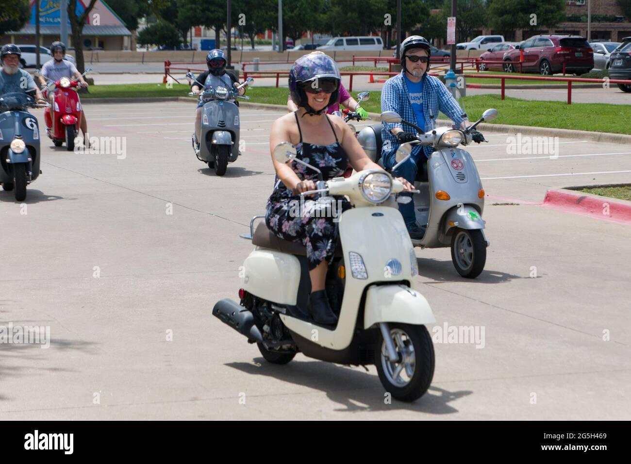 Plano, USA. 27th June, 2021. People ride Vespa during the National Vespa Parade Day in Plano, Texas, the United States, on June 27, 2021. Nearly 50 Vespa enthusiasts participated in a Vespa parade in Plano on Sunday. Credit: Dan Tian/Xinhua/Alamy Live News Stock Photo
