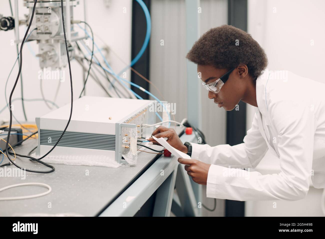 Scientist african american woman working in laboratory with electronic ...