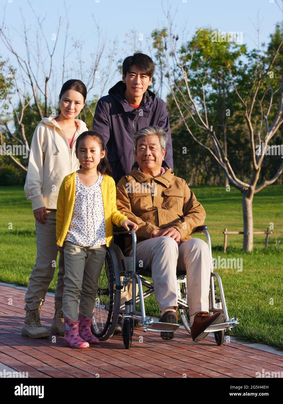 A happy family of four walking in the park high quality photo Stock ...