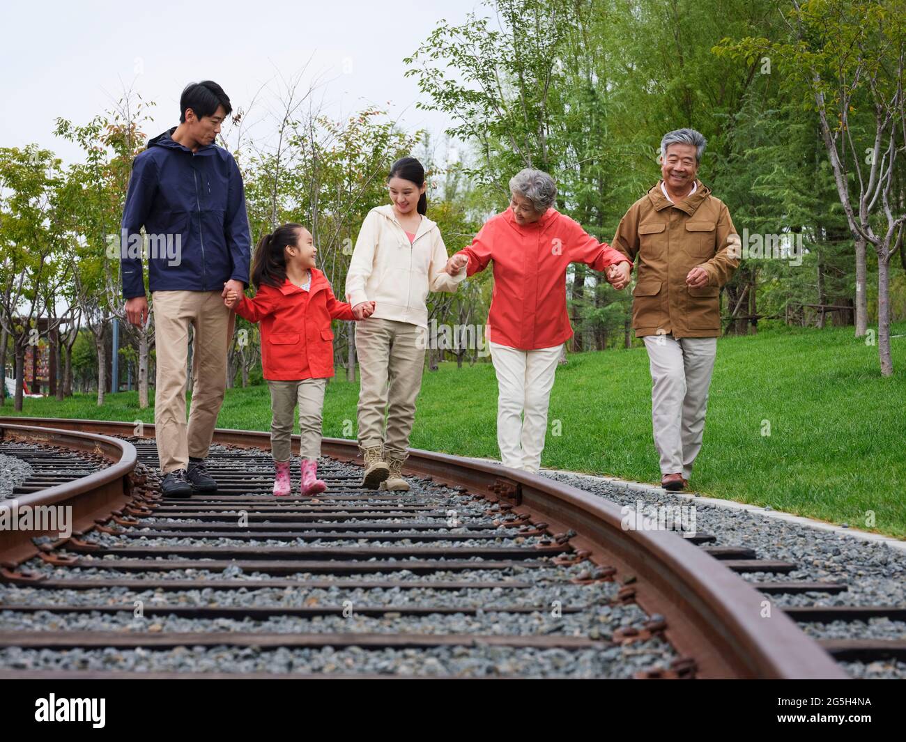 A happy family of five walking outdoors high quality photo Stock Photo