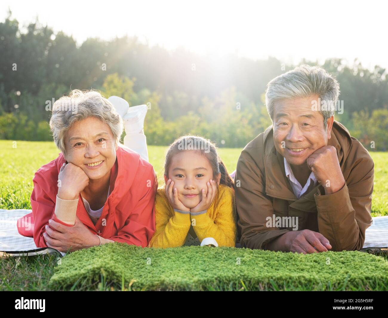 Happy grandparents and grandchildren take a group photo in the park high quality photo Stock Photo