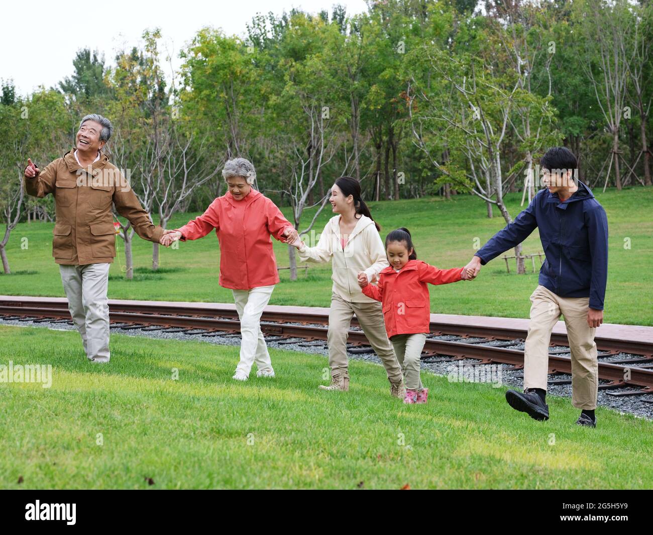 A happy family of five walking outdoors high quality photo Stock Photo