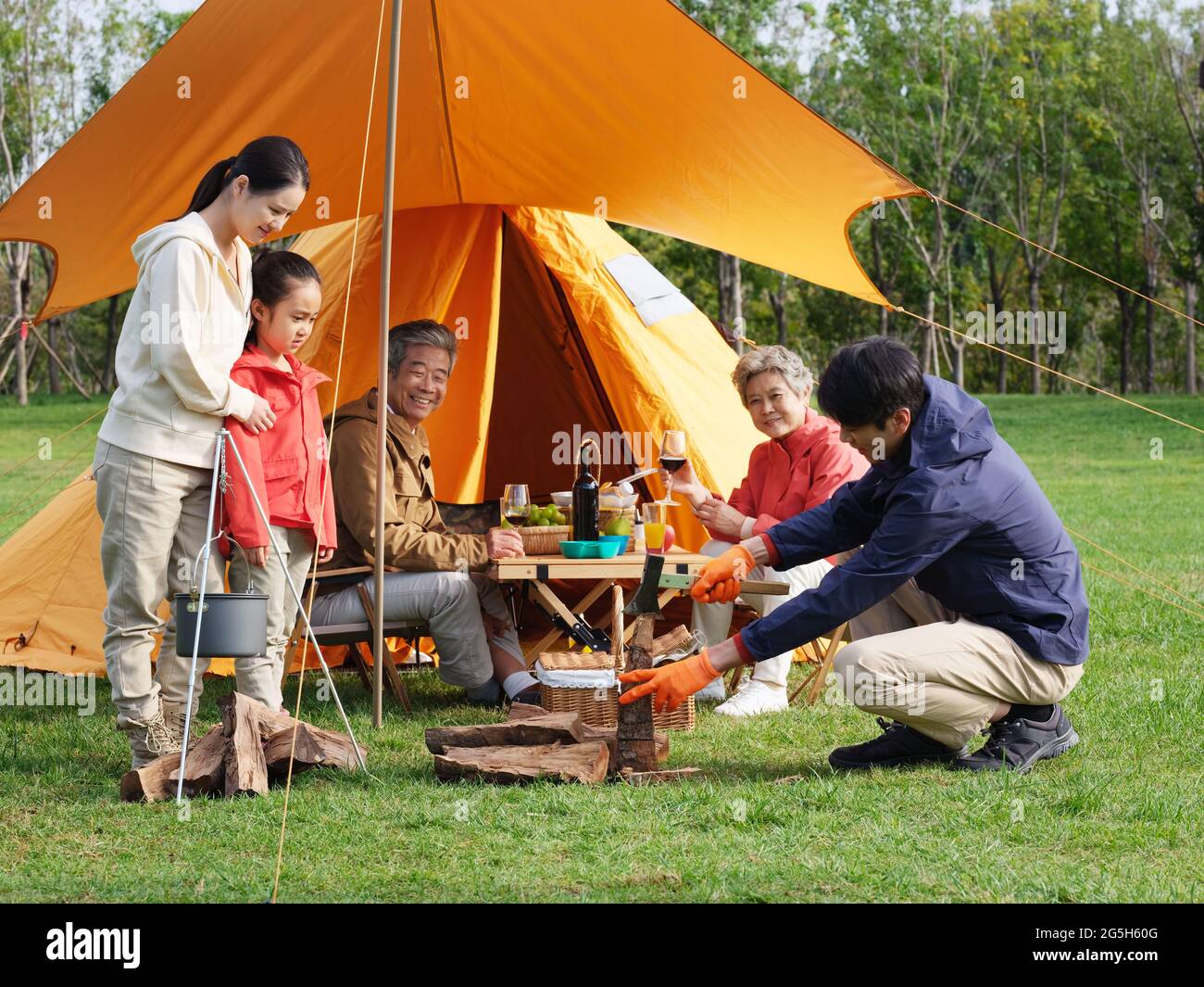 A happy family of five having a picnic outdoors high quality photo Stock Photo