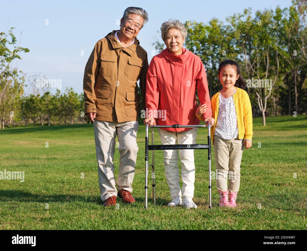 Happy grandparents and grandchildren walking in the park high quality photo Stock Photo