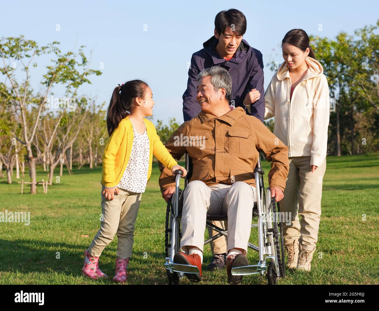 A happy family of four walking in the park high quality photo Stock ...