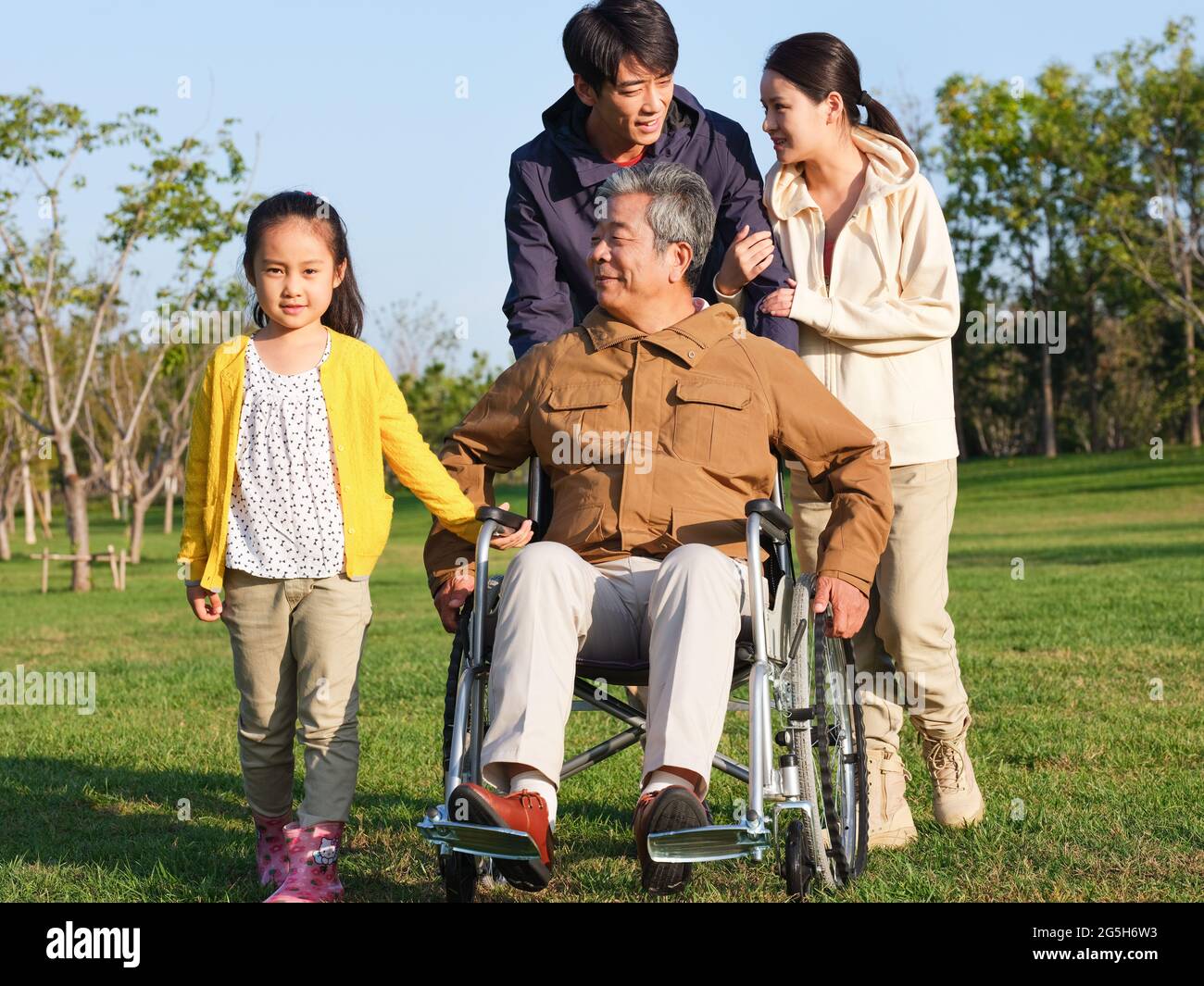 A happy family of four walking in the park high quality photo Stock Photo