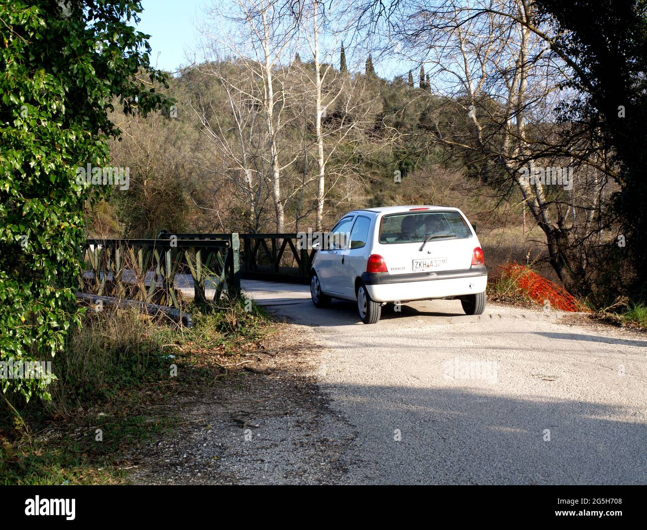 Car crossing old wooden slat road bridge connecting Karousades with Sidari, Corfu, Greece Stock Photo