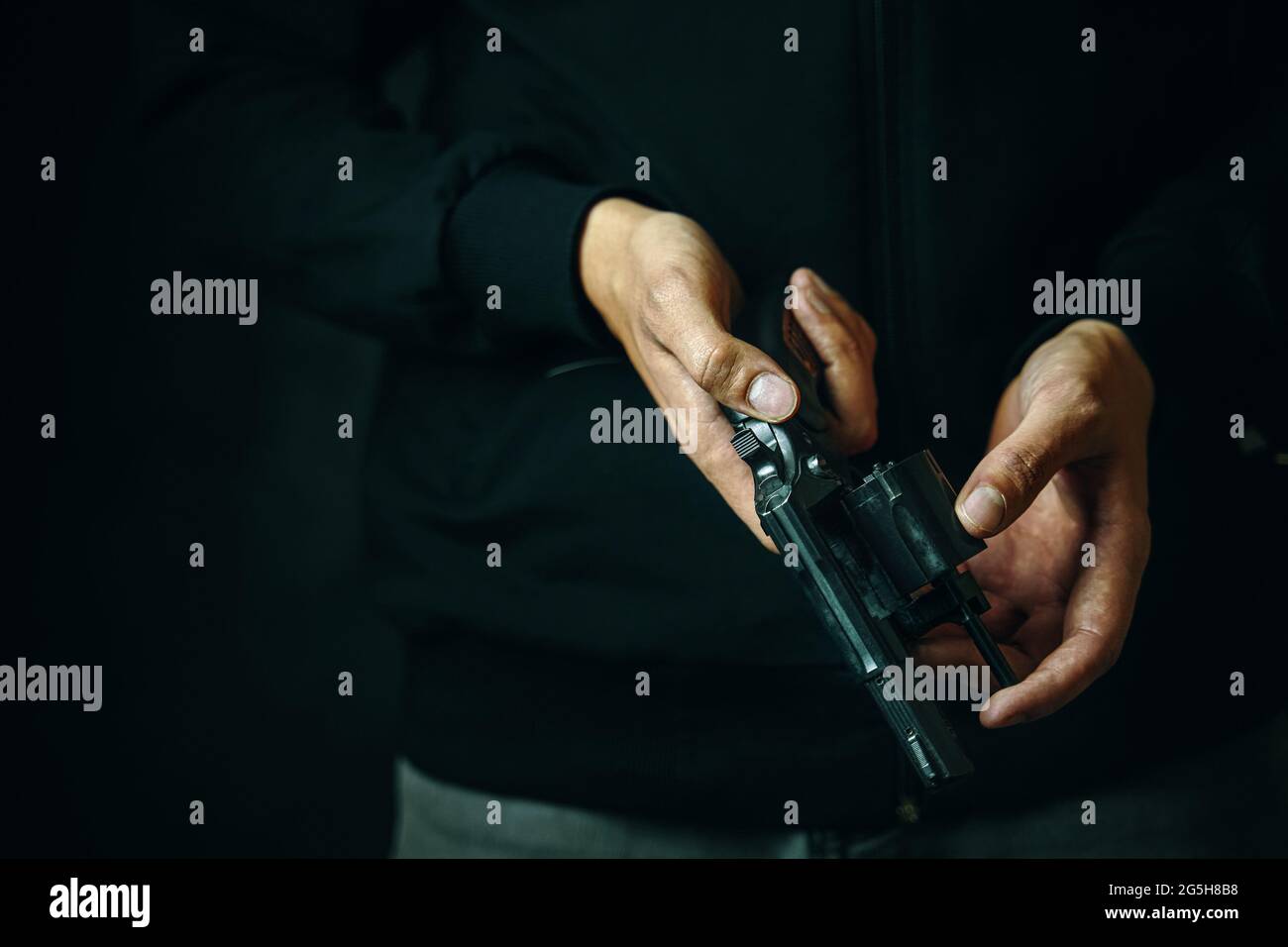Reloading revolver close-up. Men's hands check for bullets in gun ...