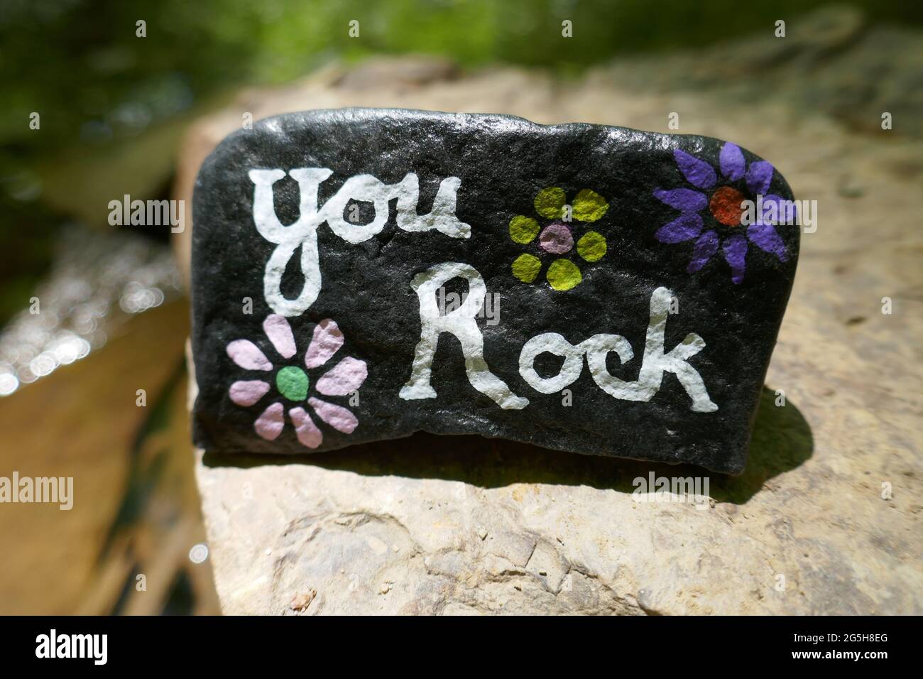 Close-up of kindness rock with You Rock message painted on Stock Photo