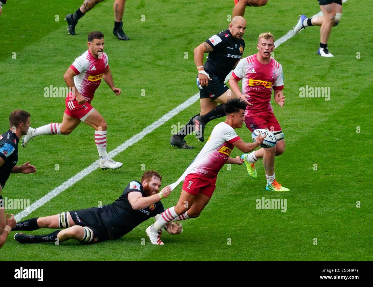 Harlequins  fly-half Marcus Smith offloads the ball to  flanker Kennigham during the Gallagher Premiership Rugby Final, Exeter Chiefs -V- Harlequins, Stock Photo