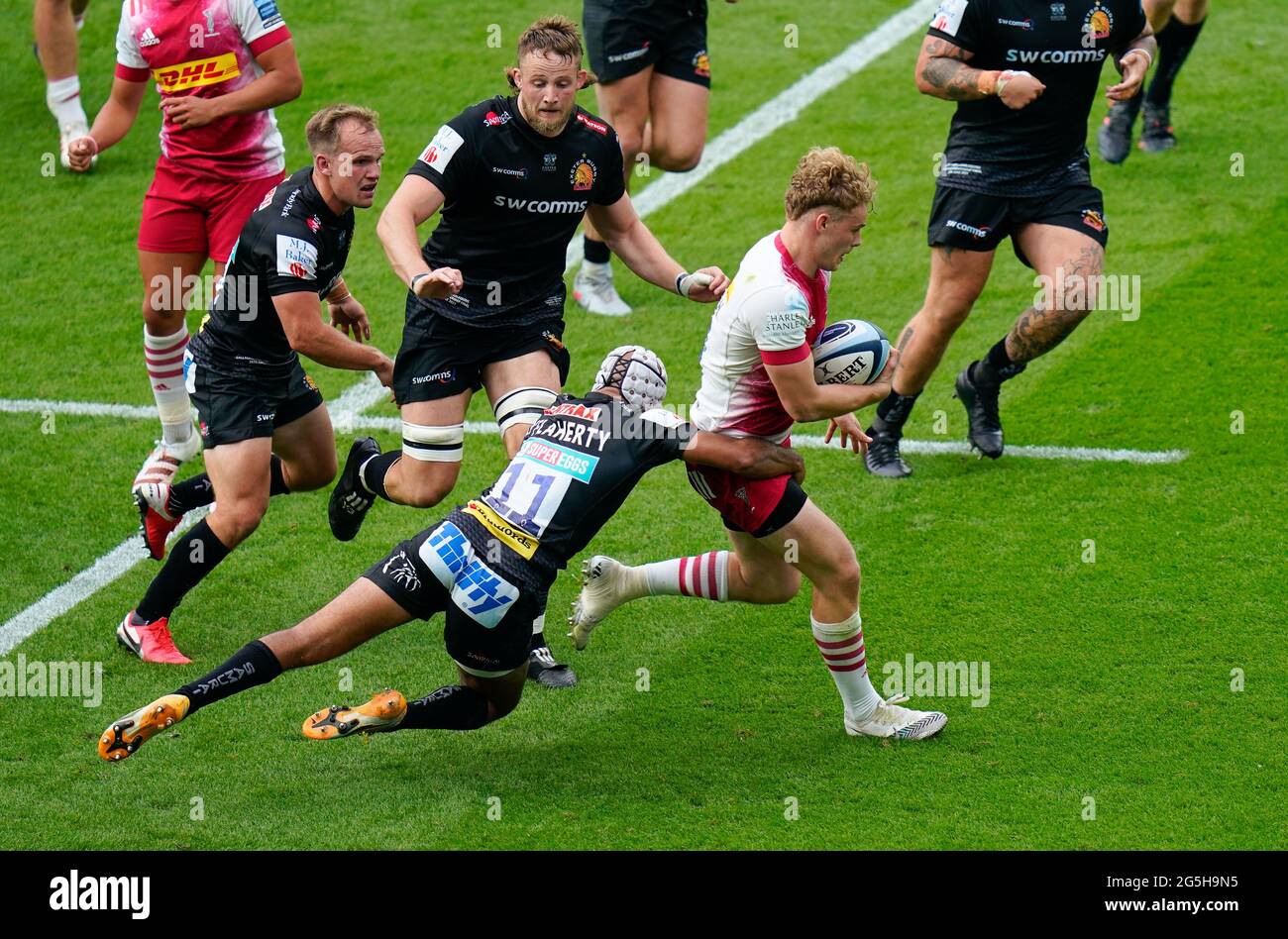Harlequins wing Louis Lynagh breaks through the tackle of Exeter Chiefs  wing Tom O'Flaherty during the Gallagher Premiership Rugby Final, Exeter  Chief Stock Photo - Alamy