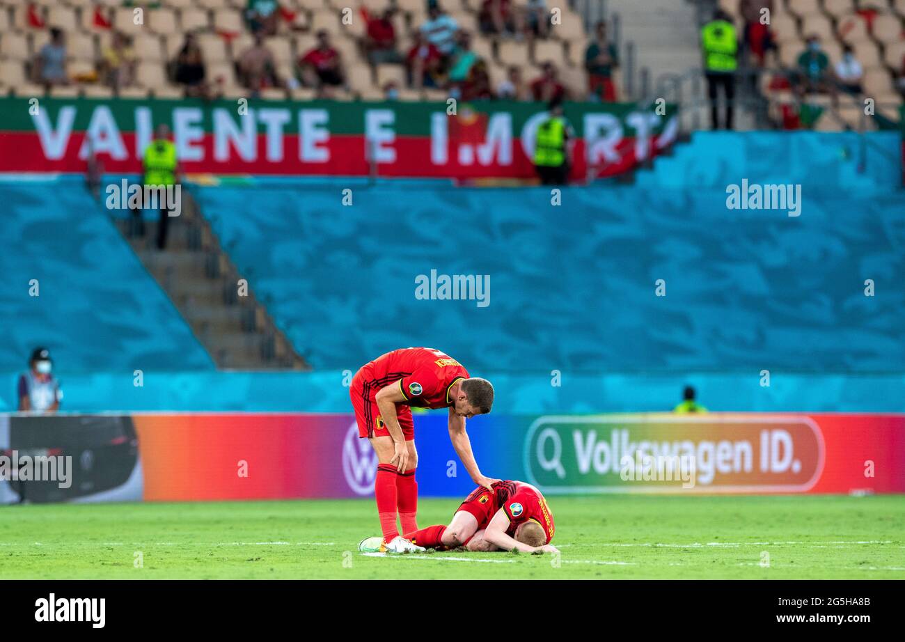 Seville, Spain. 27th June, 2021. Belgium's Kevin De Bruyne (bottom) gets injured during the Round of 16 match between Belgium and Portugal at the UEFA EURO 2020 Championship in Seville, Spain, on June 27, 2021. Credit: Meng Dingbo/Xinhua/Alamy Live News Stock Photo