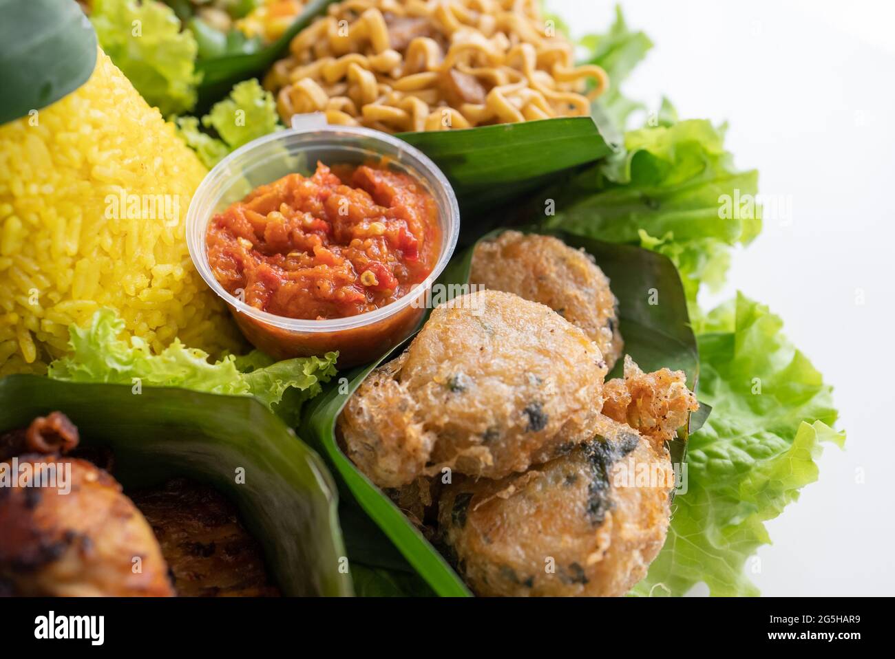 nasi tumpeng. indonesian cuisine yellow rice on banana leaf Stock Photo