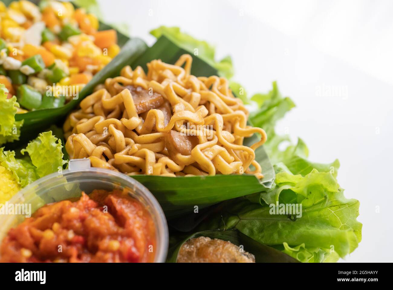 nasi tumpeng. indonesian cuisine yellow rice on banana leaf Stock Photo ...