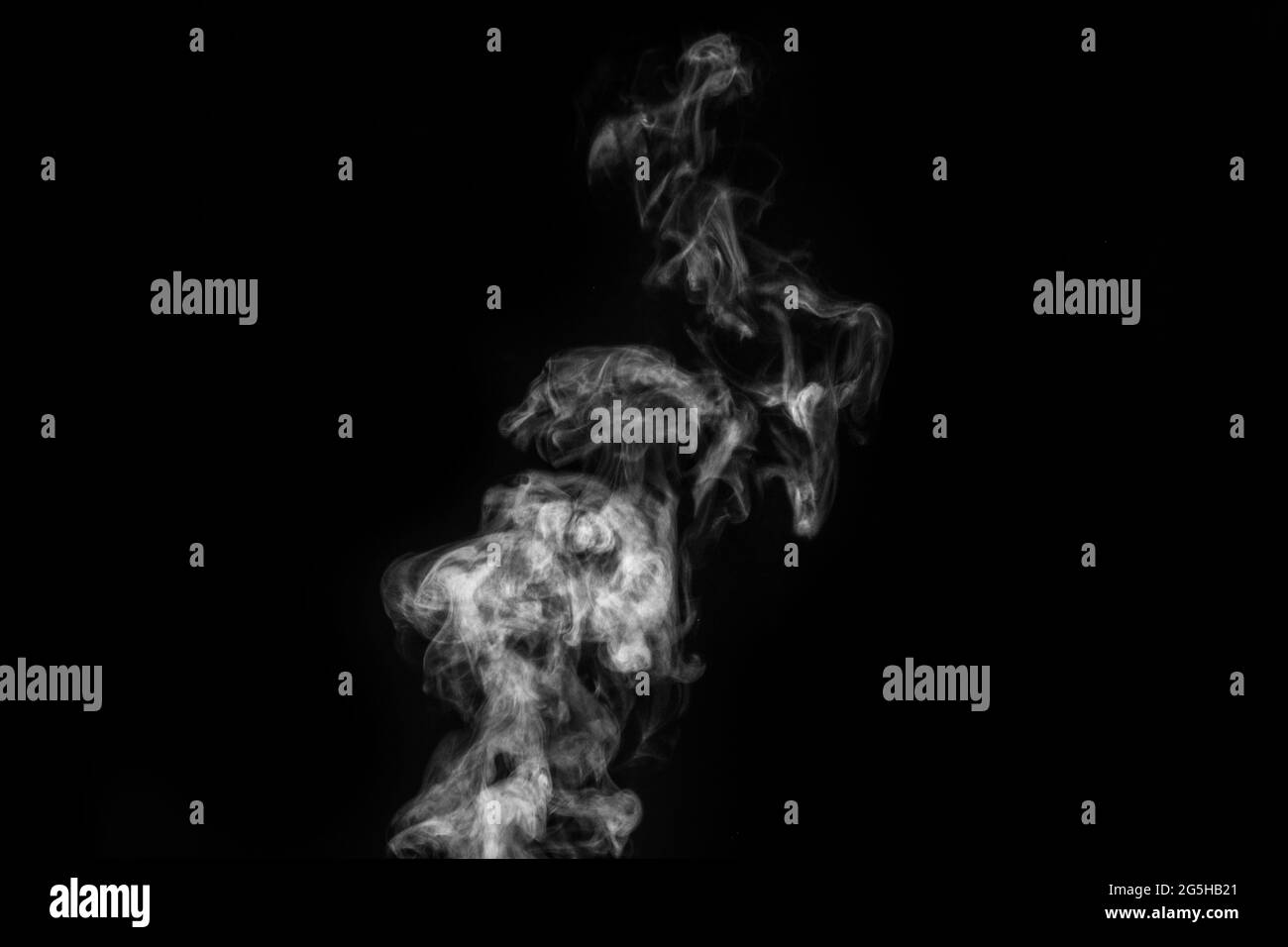 White smoke on black background. Figured smoke on a dark background. Abstract background, design element, for overlay on pictures Stock Photo