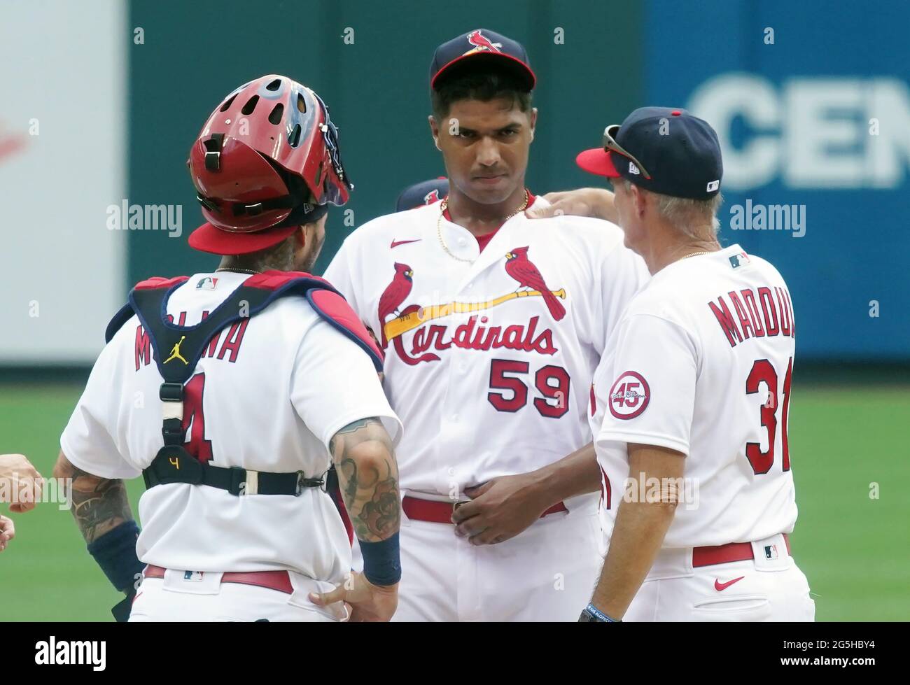 St. Louis, United States. 27th June, 2021. St. Louis Cardinals starting  pitcher Johan Oviedo gets a mound visit by catcher Yadier Molina and  pitching coach Mike Maddux after getting into trouble in