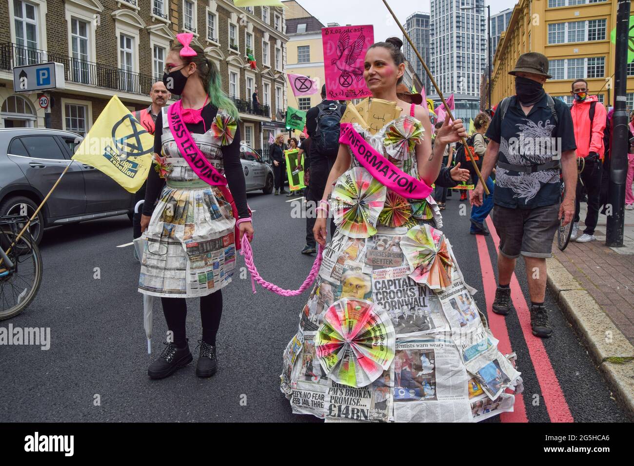 London, UK. 27th June, 2021. Demonstrators wearing dresses made of newspapers march during the Free The Press protest.Extinction Rebellion demonstrators marched from Parliament Square to News UK headquarters, owned by Rupert Murdoch, in protest of corruption, and the inaccurate and insufficient coverage of the climate and environmental crisis by several major UK newspapers owned by billionaires. (Photo by Vuk Valcic/SOPA Images/Sipa USA) Credit: Sipa USA/Alamy Live News Stock Photo