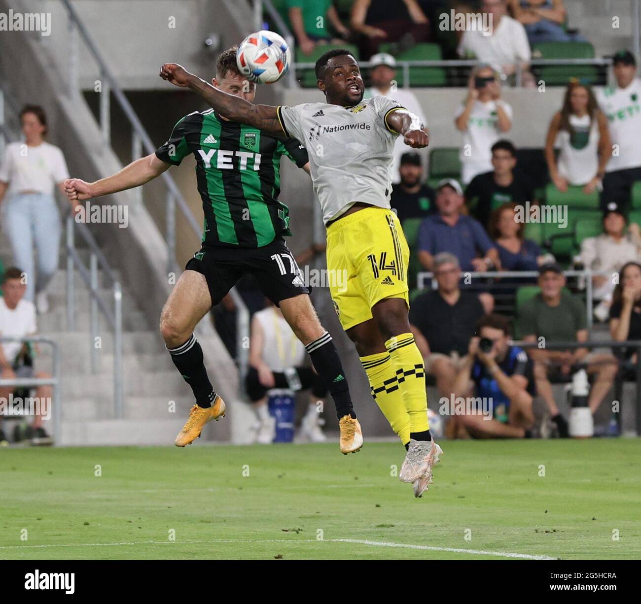 Austin, Texas, USA. 27th June, 2021. Columbus Crew defender Waylon Francis (14) heads the ball away to deflect a pass to Austin FC forward Jon Gallagher (17) during the second half of a Major League Soccer match between Austin FC and the Columbus Crew on June 27, 2021 in Austin, Texas. The teams played to a 0-0 draw. Credit: Scott Coleman/ZUMA Wire/Alamy Live News Stock Photo
