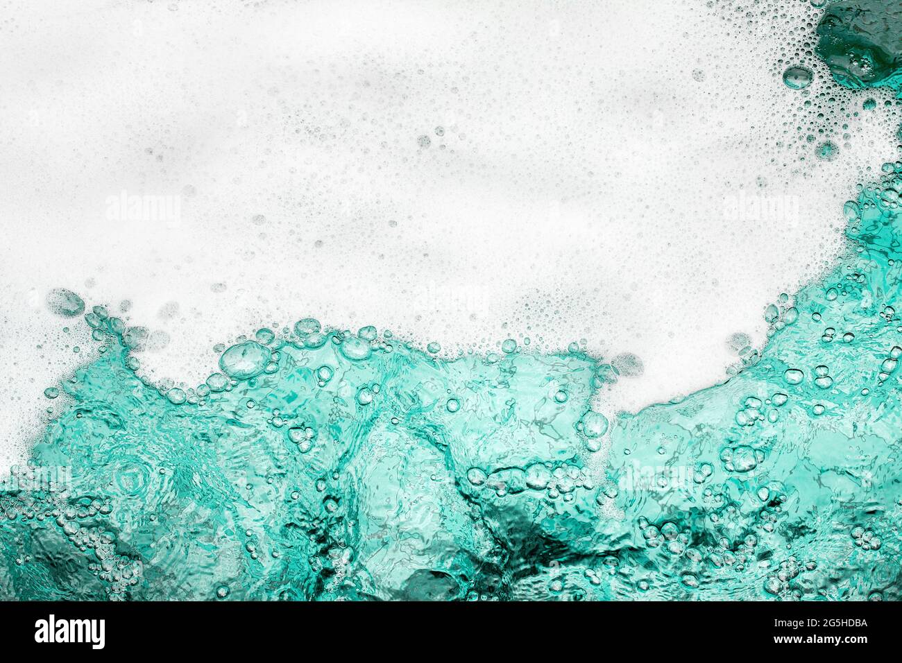 Blue sea water white foam texture background closeup, foamy ocean wave