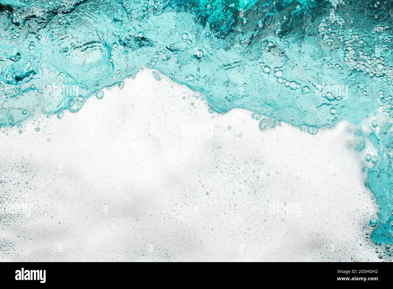 Blue sea water white foam texture background closeup, foamy ocean wave