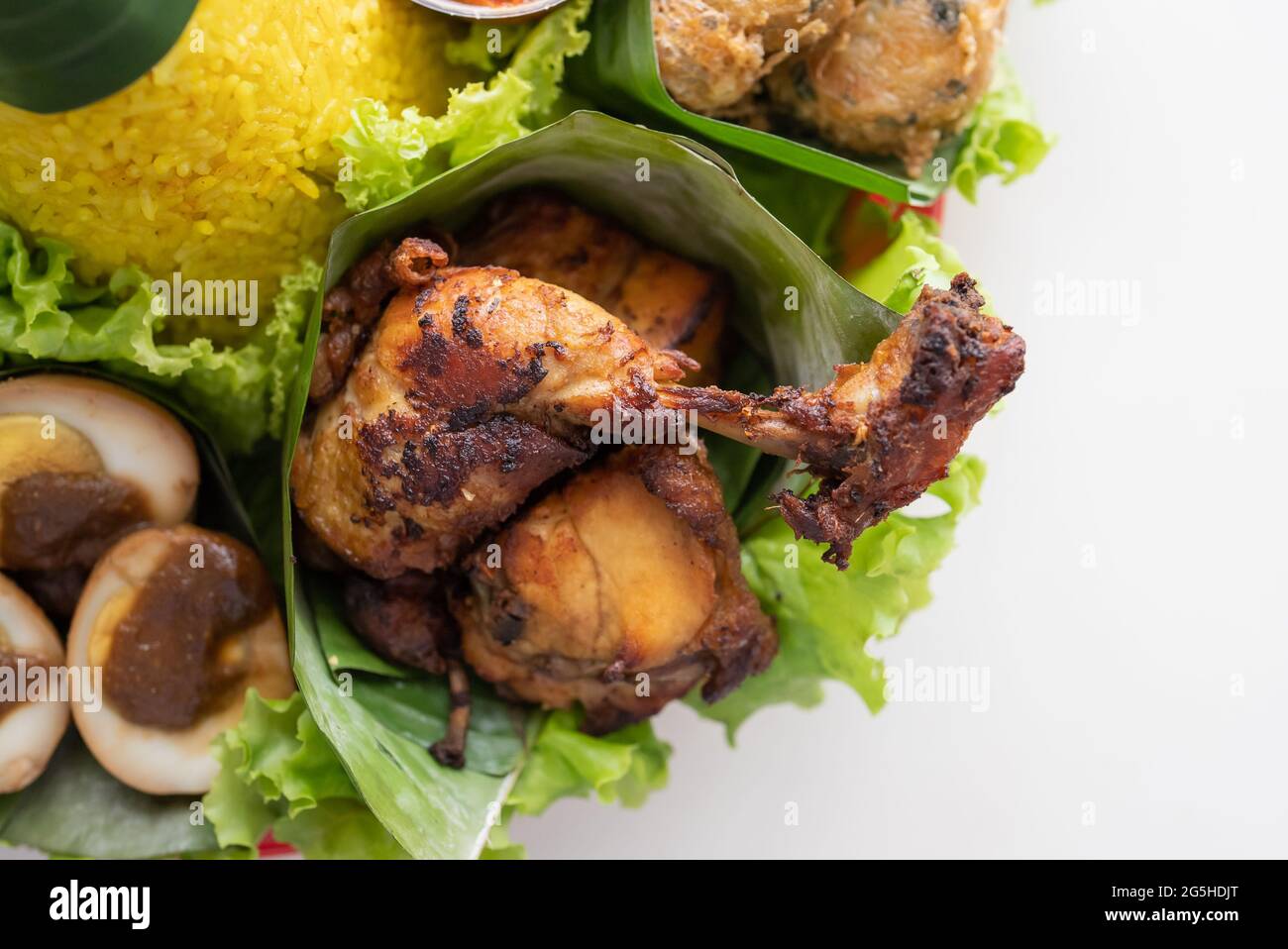 nasi tumpeng. indonesian cuisine yellow rice on banana leaf Stock Photo ...