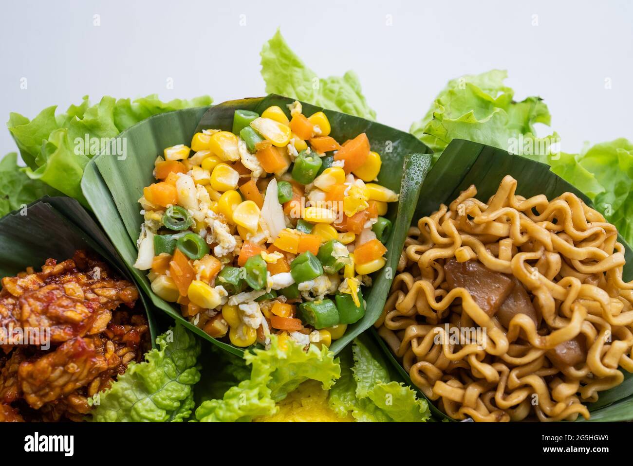 nasi tumpeng. indonesian cuisine yellow rice on banana leaf Stock Photo