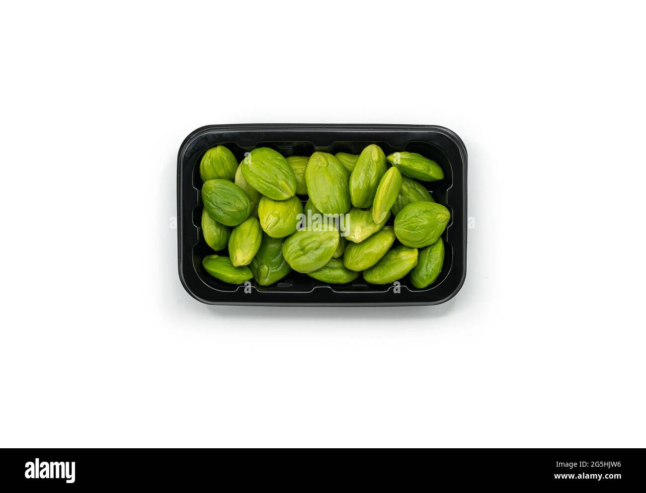 Top view fresh bitter beans in a plastic black tray for sale on white background, bitter beans or Sator in Thailand language. Stock Photo