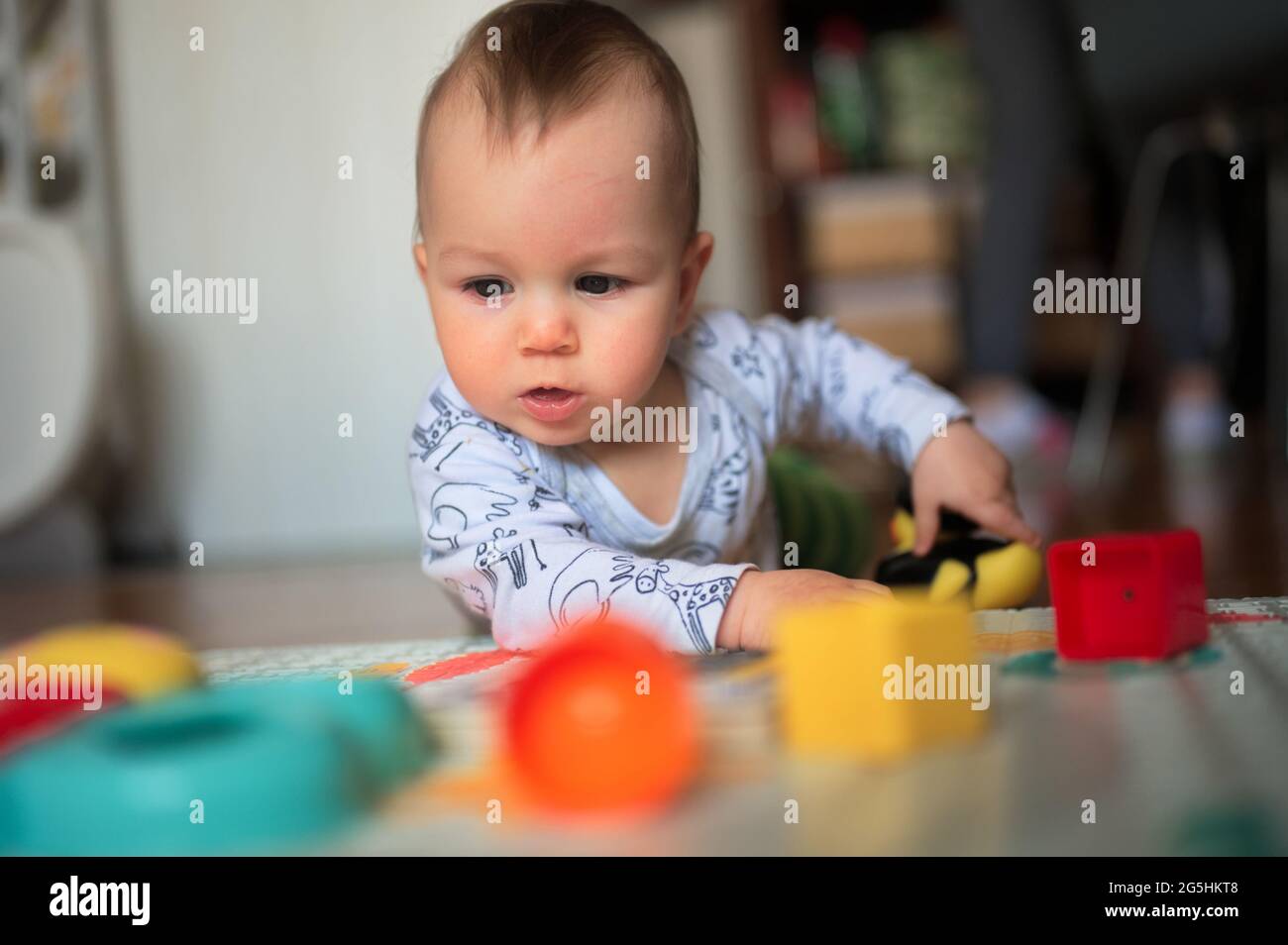 Portrait of cute little baby playing Stock Photo Alamy
