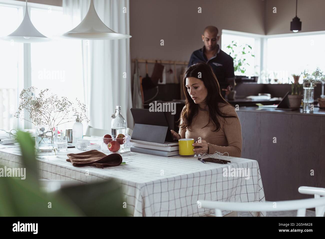 Female professional working on digital tablet at home Stock Photo