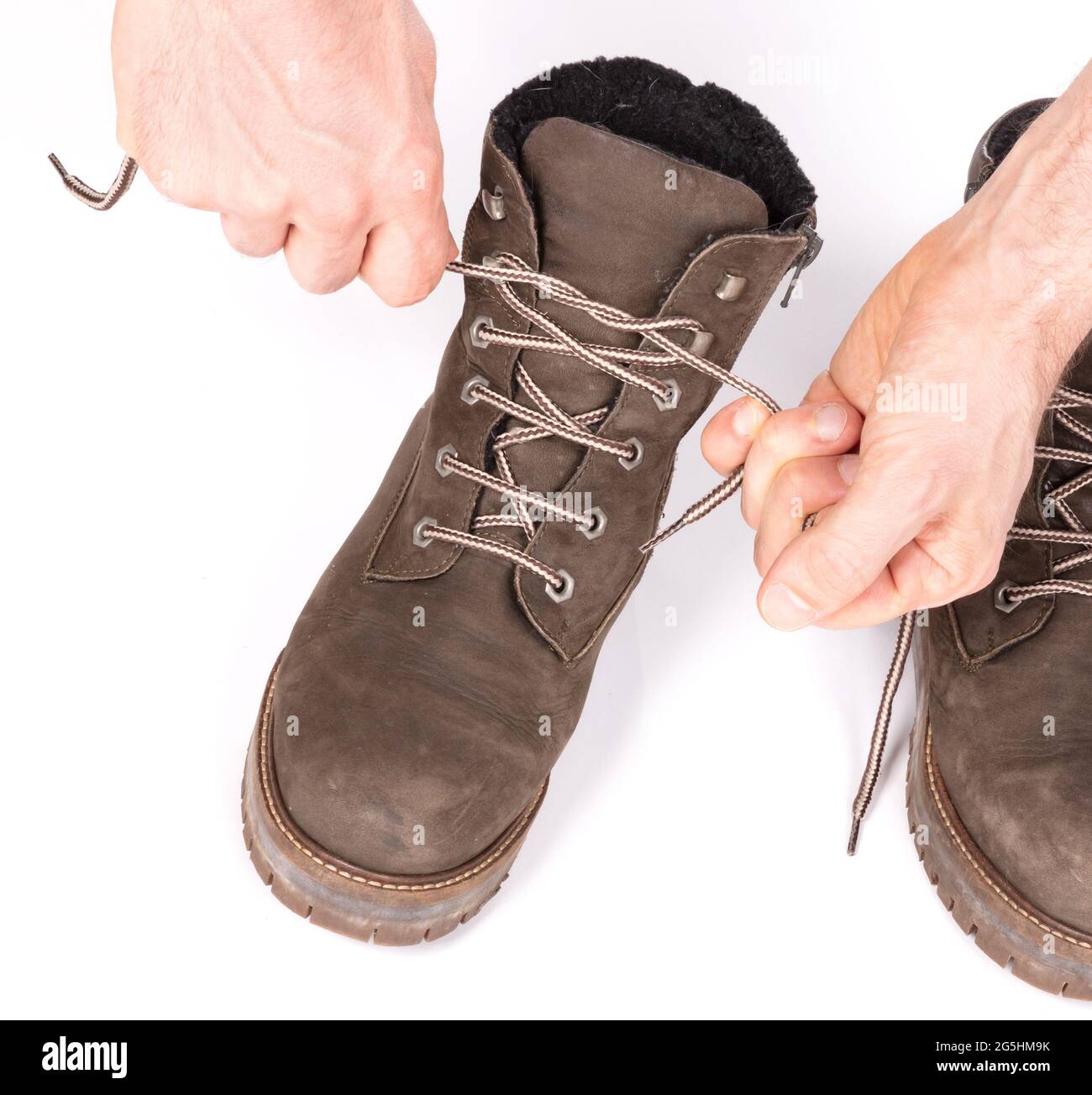 Tying laces of a hiking boot, isolated on white Stock Photo Alamy