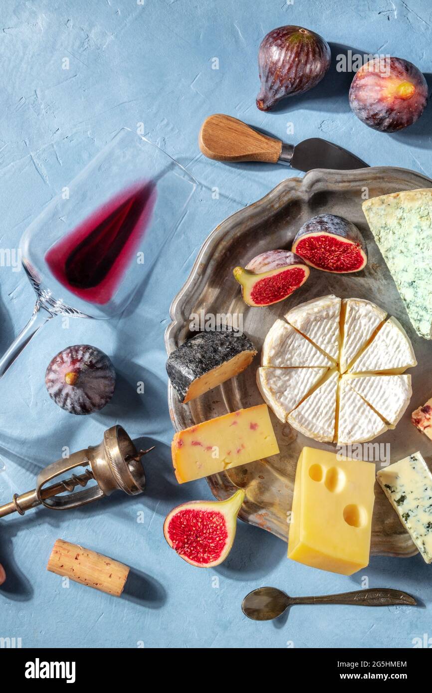 Cheese and wine, top shot. Cheese board with Brie and fruits, with a