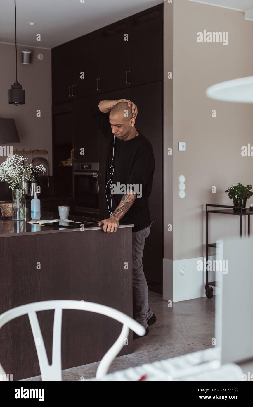 Businessman using digital tablet in kitchen at home Stock Photo